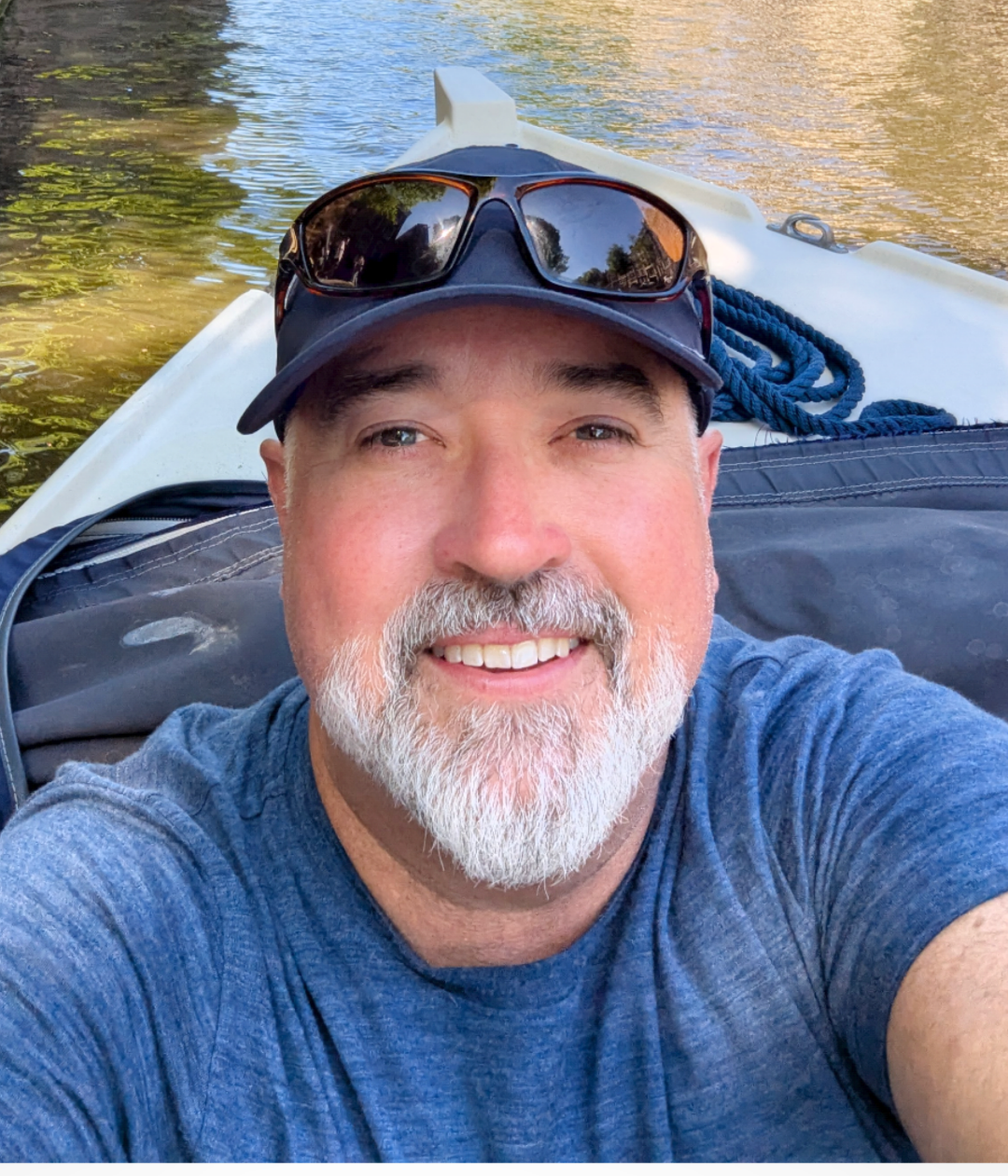 Brian Applegarth smiling outdoors on the water